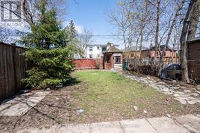 Toronto (Lansing-Westgate) apartment for rent - A backyard with a tree, a fence, and a shed.