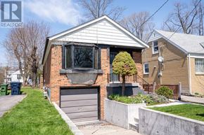 Toronto (Lansing-Westgate) apartment for rent - A house with a grey garage door and a brick chimney.