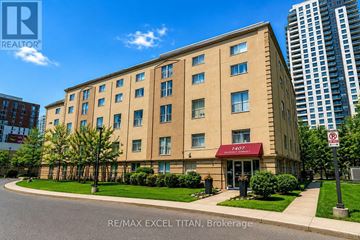 Toronto (Dovercourt-Wallace Emerson-Junction) condo for rent - A building with the sign RE/MAX EXCEL TITAN, Brokerage in front of it.