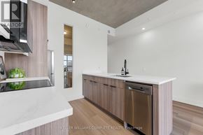 Hamilton (Corktown) condo for rent - A modern kitchen with a white countertop and a stainless steel dishwasher.
