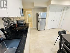 Vancouver apartment for rent - A bedroom with a bed, dresser, and window.