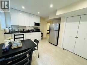Vancouver apartment for rent - A bedroom with a bed, chair, and a window.