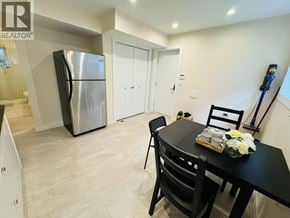 Vancouver apartment for rent - A bedroom with a bed, chair, and lamp.