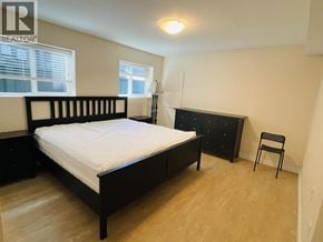 Vancouver apartment for rent - A bedroom with a bed, dresser, and chair.