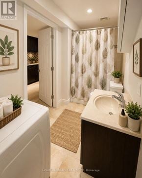 Markham (Middlefield) apartment for rent - A bathroom with a white sink and a shower curtain with a leaf pattern.