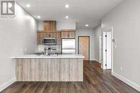 Charlottetown condo for rent - A modern kitchen with wooden cabinets and a white island.
