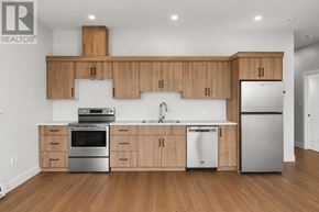 Charlottetown condo for rent - A modern kitchen with wooden cabinets and stainless steel appliances.