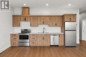 Charlottetown condo for rent - A modern kitchen with wooden cabinets and stainless steel appliances.