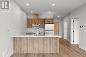 Charlottetown condo for rent - A modern kitchen with wooden cabinets and a white countertop.