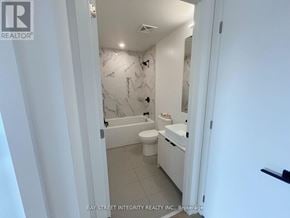 Toronto (Dovercourt-Wallace Emerson-Junction) condo for rent - A white bathroom with a marble wallpaper and a toilet.