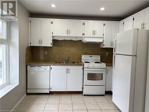 Hamilton (Kirkendall) apartment for rent - A kitchen with white appliances and cabinets.