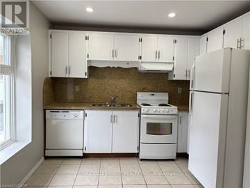 Hamilton (Kirkendall) apartment for rent - A kitchen with white appliances and cabinets.