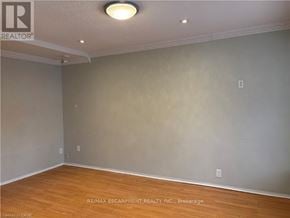 Hamilton (Kirkendall) apartment for rent - A room with a wooden floor and a light on the ceiling.