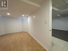Vaughan (Patterson) apartment for rent - A room with wooden flooring and white walls.