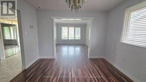 Hamilton (Fessenden) apartment for rent - A room with wooden floors and a chandelier.