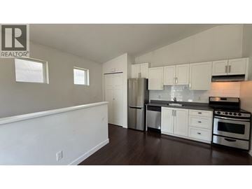 Coquitlam apartment for rent - A kitchen with white cabinets and stainless steel appliances.