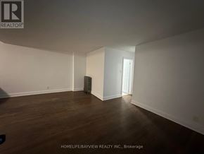 Toronto (Keelesdale-Eglinton West) apartment for rent - A room with wooden floors and white walls, with a doorway visible in the background.