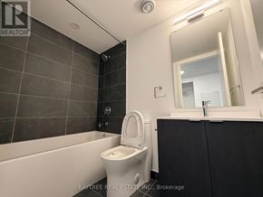 Toronto (Church-Yonge Corridor) condo for rent - A bathroom with a white toilet and a black cabinet.