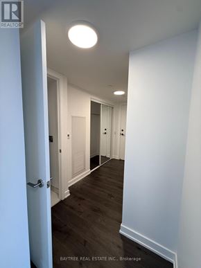 Toronto (Church-Yonge Corridor) condo for rent - A hallway with white walls and wood floors.