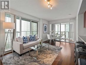 Toronto (Bendale) condo for rent - A well-lit living room with a couch, chairs, and a coffee table.