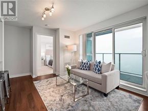 Toronto (Bendale) condo for rent - A living room with a couch, a glass table, and a view of the ocean.