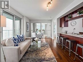 Toronto (Bendale) condo for rent - A living room with a couch, a table, and a bar area.