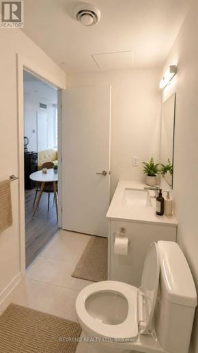 Toronto (Willowdale West) condo for rent - A white toilet in a bathroom with a sink and mirror.