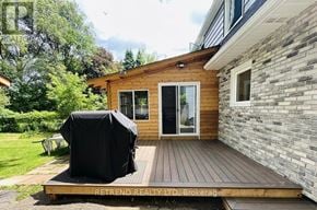 Toronto (Lansing-Westgate) apartment for rent - A wooden deck with a black cover is in front of a house.