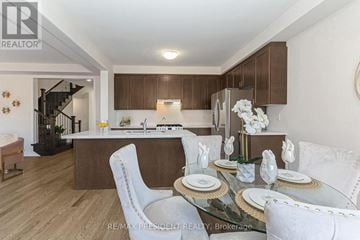 Erin apartment for rent - A modern kitchen with a dining table set for two.