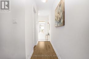 Erin apartment for rent - A hallway with a painting on the wall and a light switch on the wall.