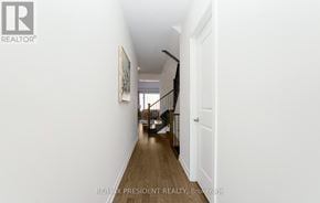 Erin apartment for rent - A hallway with a wooden floor and white walls.