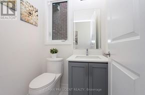 Erin apartment for rent - A white toilet sits next to a sink in a small bathroom.