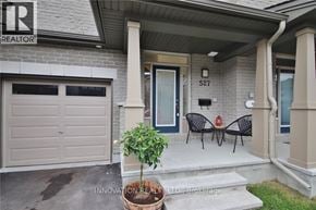 Ottawa townhouse for rent - A house with a sign that says "REALTOR" on the left side of the entrance.