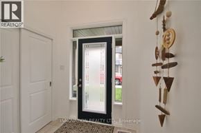 Ottawa townhouse for rent - A door with a glass window is in the middle of a hallway.