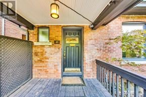 Toronto (Wychwood) apartment for rent - A green door is the centerpiece of this front porch.
