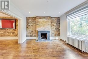 Toronto (Wychwood) apartment for rent - A room with a fireplace and a brick wall.