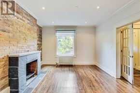 Toronto (Wychwood) apartment for rent - A room with a fireplace and a window.