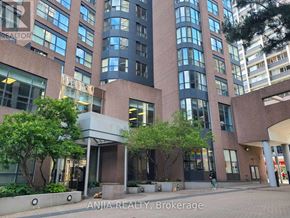 Toronto (Church-Yonge Corridor) condo for rent - A building with a sign that says "ANJIA REALTY, Brokerage" in front of it.