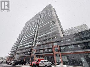 Oshawa (Windfields) condo for rent - A tall building with a Bay Street Group Inc. sign in front of it.