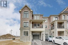 Richmond Hill townhouse for rent - A large two-story residential building with a garage and a car parked in front.