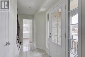 Richmond Hill townhouse for rent - A hallway with a glass door and a white door.