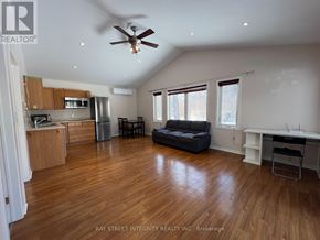 Oakville (Wo West) apartment for rent - A spacious living room with wood flooring and a ceiling fan.