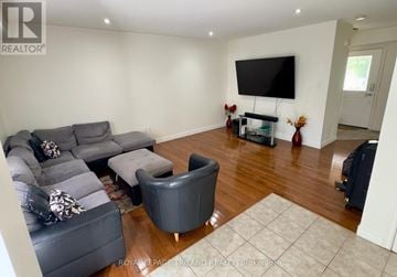 London North (North M) apartment for rent - A living room with a grey sofa and a black television.