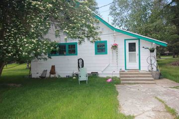Whitefish apartment for rent - A white house with a green roof and a white door.