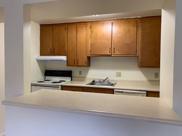 Elkhart apartment for rent - A kitchen with wooden cabinets and a stove top oven.