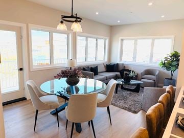 Selkirk apartment for rent - A modern dining room with a glass table and chairs.
