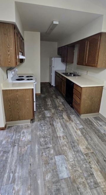 Grand Rapids apartment for rent - A kitchen with wooden cabinets and a tiled floor.