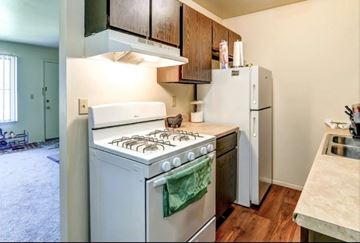 Wyoming apartment for rent - A kitchen with a white stove and refrigerator.