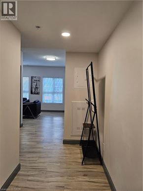 Waterloo condo for rent - A hallway with a realtor logo on the bottom left.