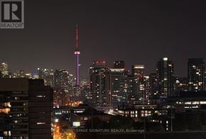 Toronto (South Parkdale) condo for rent - A cityscape at night with the CN Tower prominently lit up.